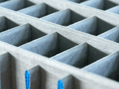 Cartonplast compartmentations laminated with non woven textile